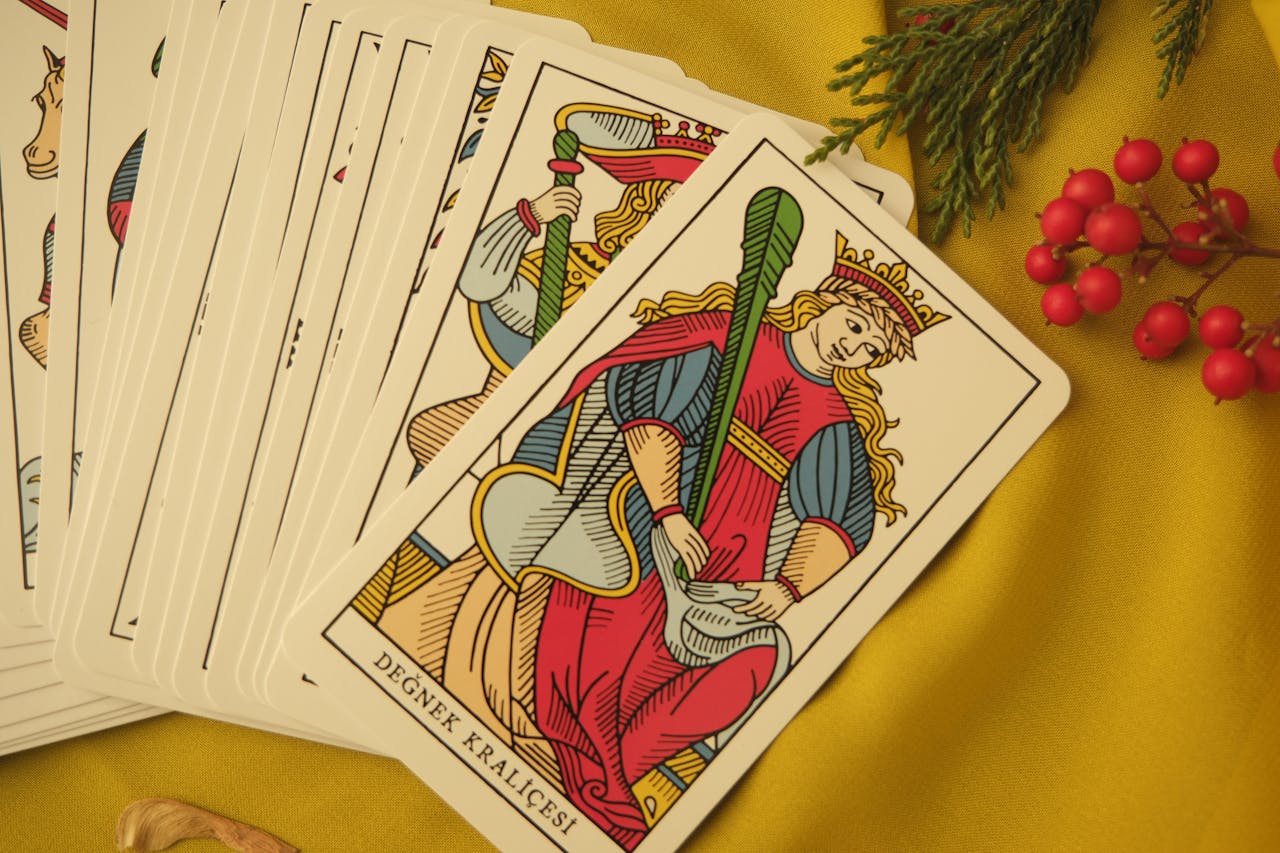 about-04 Tarot cards featuring Degnek Kralicesi on fabric with red berries.